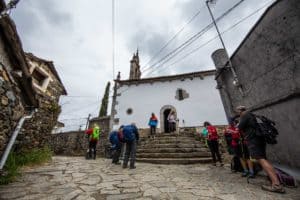pilgrims entering Church of San Juan before pulpo town 
